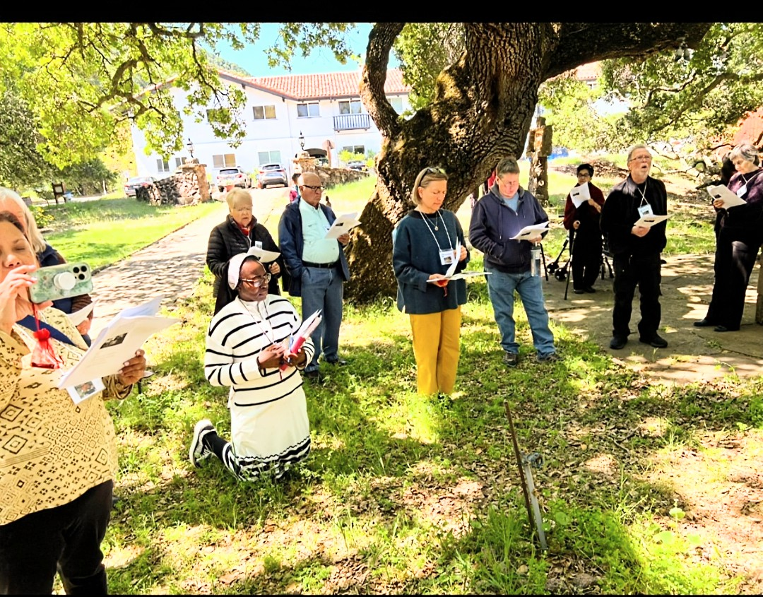 Sister Felicia kneeling in prayer during outdoor Stations of the Cross