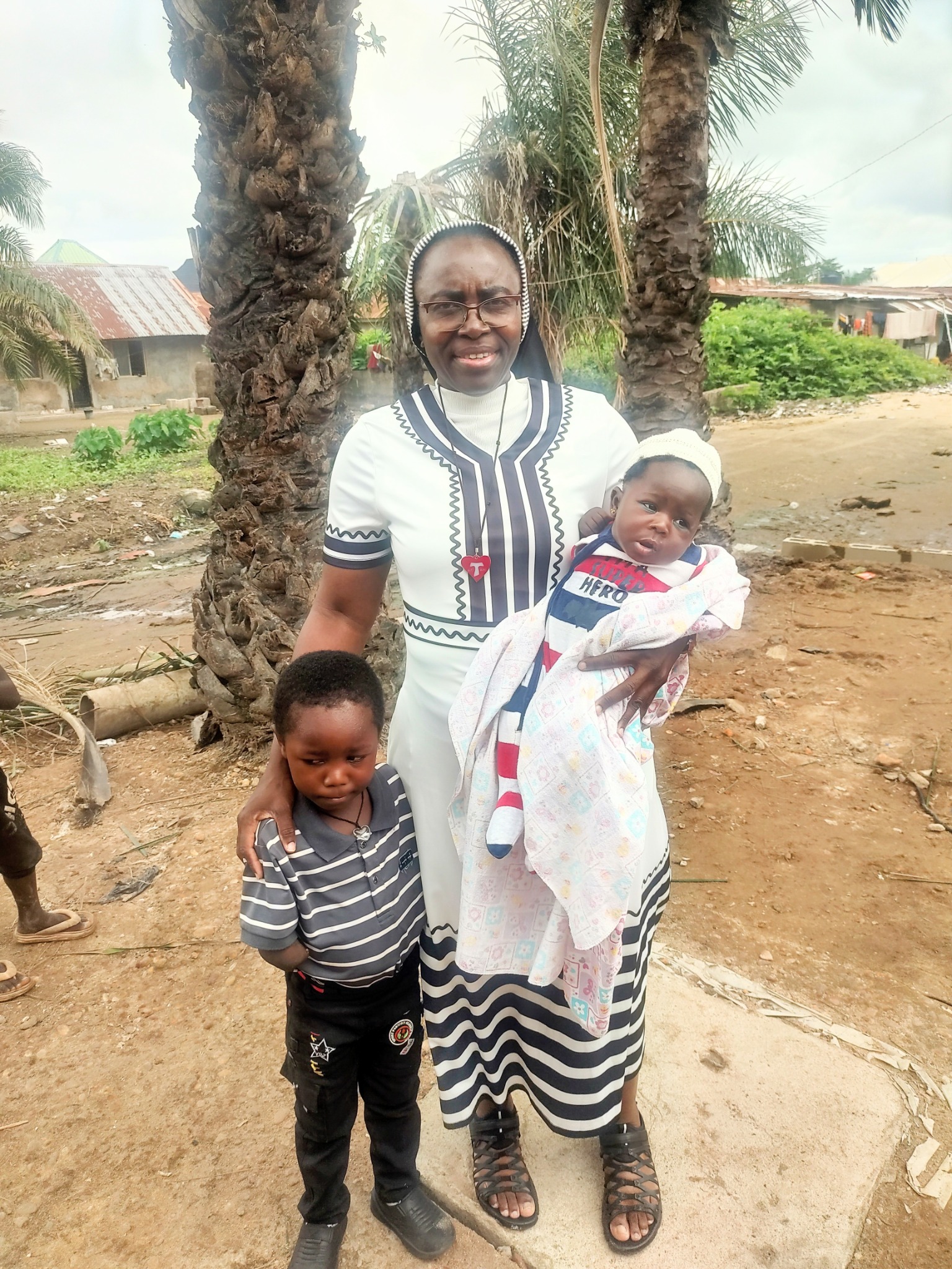 Sister Felicia with children during ACMC mission outreach
