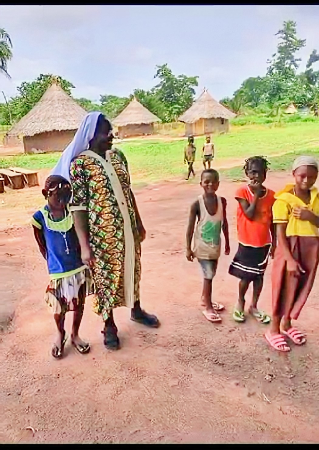 ACMC sister with village children during evangelization outreach in Nigeria